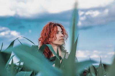 Head red woman over corn leaves