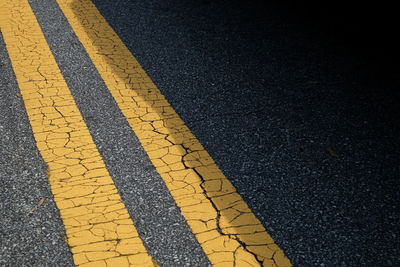 Close-up of yellow lines on road