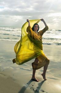 Full length of young woman at beach