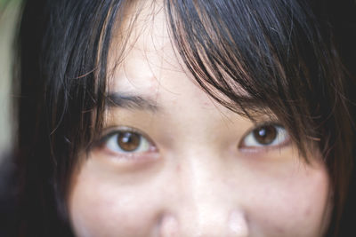 Close-up portrait of young woman with bangs