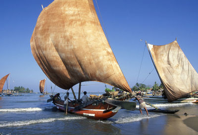 Men and boats at beach