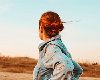 Rear view of woman looking at camera