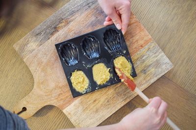 High angle view of man preparing food on cutting board