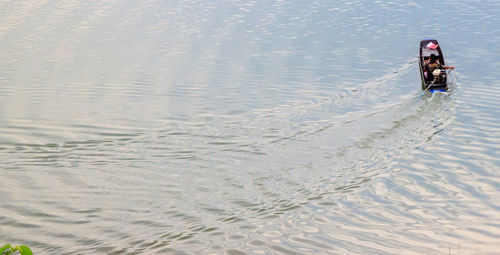 Rear view of man in sea