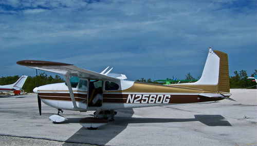 Airplane on airport runway against sky