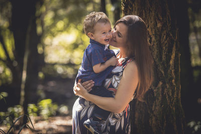 Mother and daughter on tree trunk