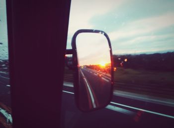 View of car on road at sunset