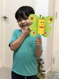 Portrait of smiling girl standing at home