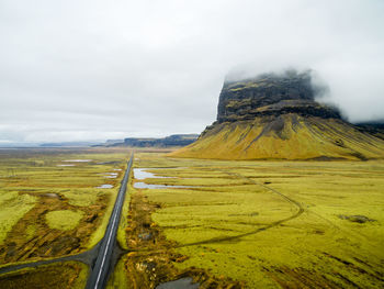 Narrow road along countryside landscape