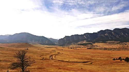 Scenic view of mountains against cloudy sky