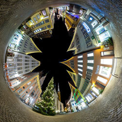 Woman in illuminated city at night