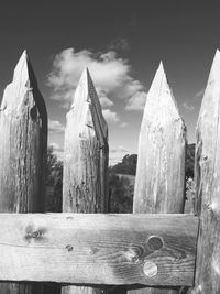 Close-up of wooden post against sky