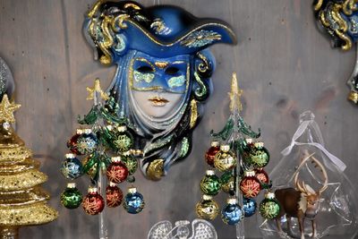 High angle view of venetian mask and small christmas tree balls