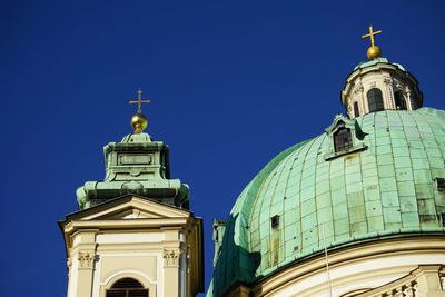 Low angle view of st peters church against clear blue sky in city