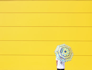 Close-up of yellow cables against the wall