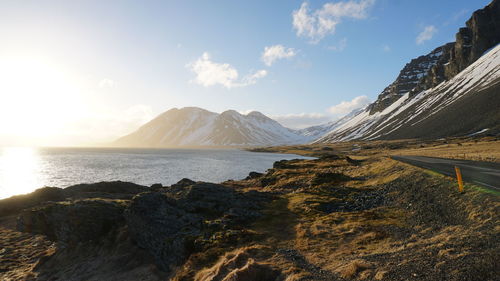 Panoramic view of sea and mountains against sky