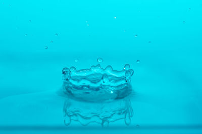 Close-up of water splashing against blue background