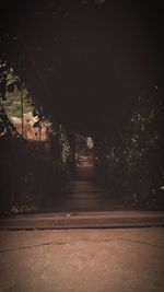 Illuminated tunnel at night