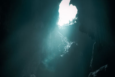 Low angle view of rock formation in water