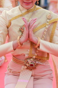 Midsection of woman in traditional clothing posing outdoors