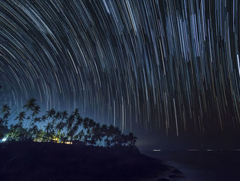 Scenic view of trees against sky at night