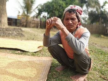 Full length of man sitting outdoors