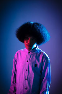 Portrait of young man against blue background