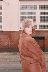 Woman  in fur hat standing in city