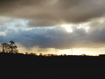 Scenic view of silhouette landscape against dramatic sky