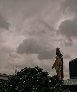 Low angle view of statue against sky