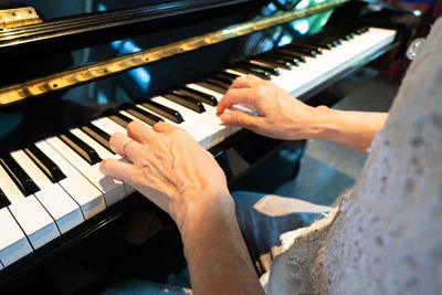 Midsection of woman playing piano