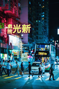 Group of people crossing road in city