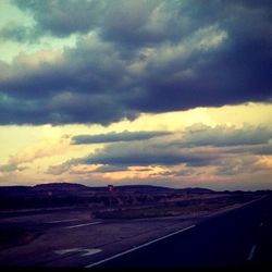 Scenic view of landscape against cloudy sky