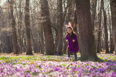Full length of a smiling girl in forest