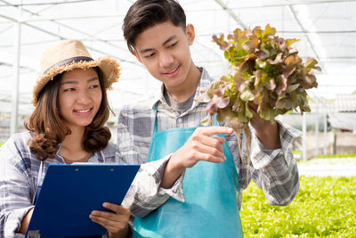 Young man doing working at greenhouse