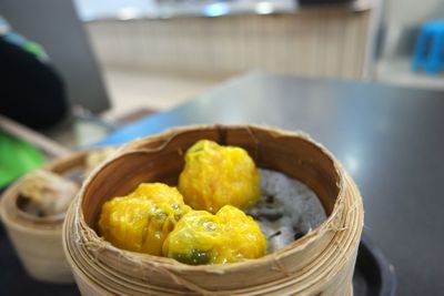 Close-up of dim sum in basket on table