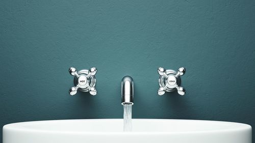 Close-up of running water from faucet over sink