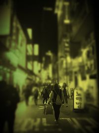 People walking on city street at night