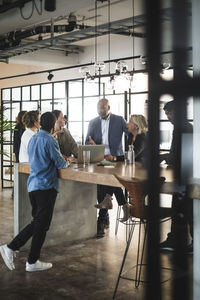 Business people sharing ideas in meeting at creative office