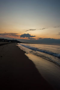 Scenic view of beach against sky during sunset