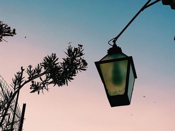 Low angle view of silhouette hanging against clear sky