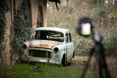 Abandoned car on field