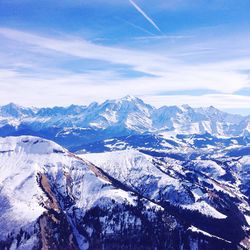 Scenic view of mountains against blue sky