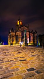 Illuminated building against sky at night