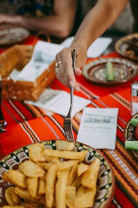 High angle view of hand holding food on table