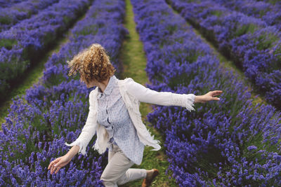 Cheerful of woman dancing on lavender field