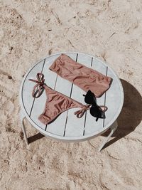 High angle view of bikini against sand