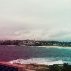 View of cityscape against cloudy sky