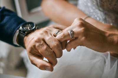 Cropped image of couple holding hands