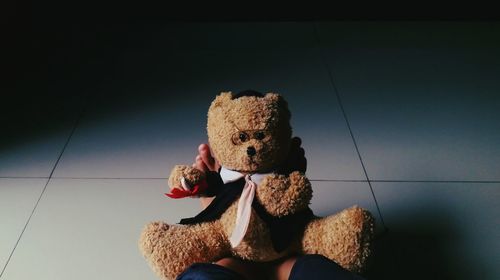 Close-up of boy holding toy on floor